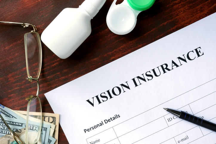 Vision insurance form on the wooden table.